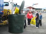 The town's garbage is collected during the Community Clean-Up is taken to a garbage truck parked outside the SNO Building in Downtown Wrangell.